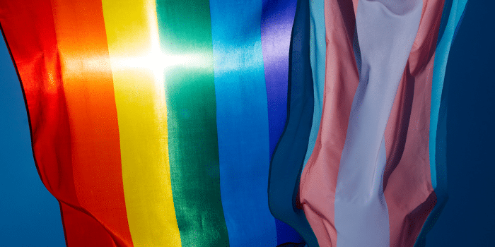 Pride Flags with sunlight shining in shape of cross