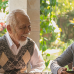 seniors smiling and conversing at a table