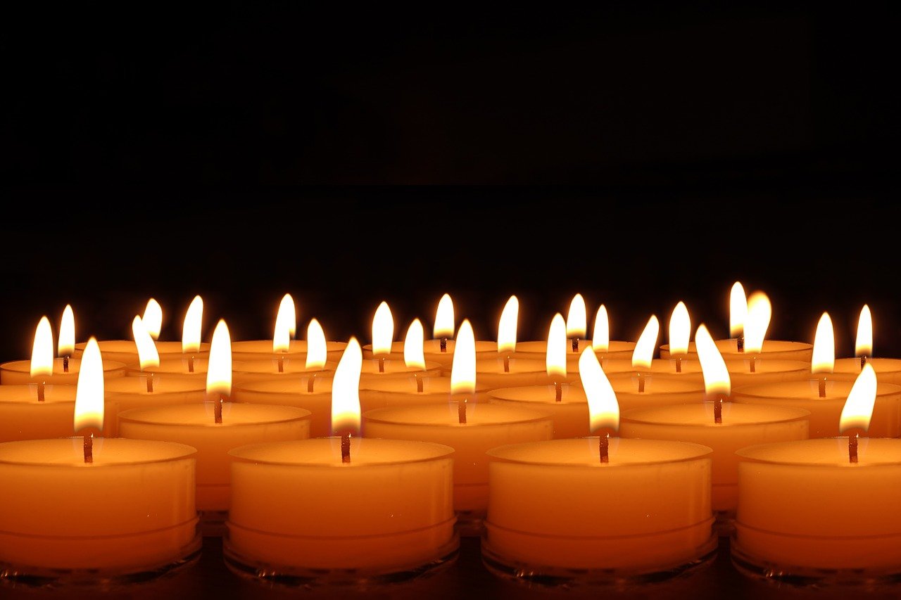 Candles glowing against a dark background