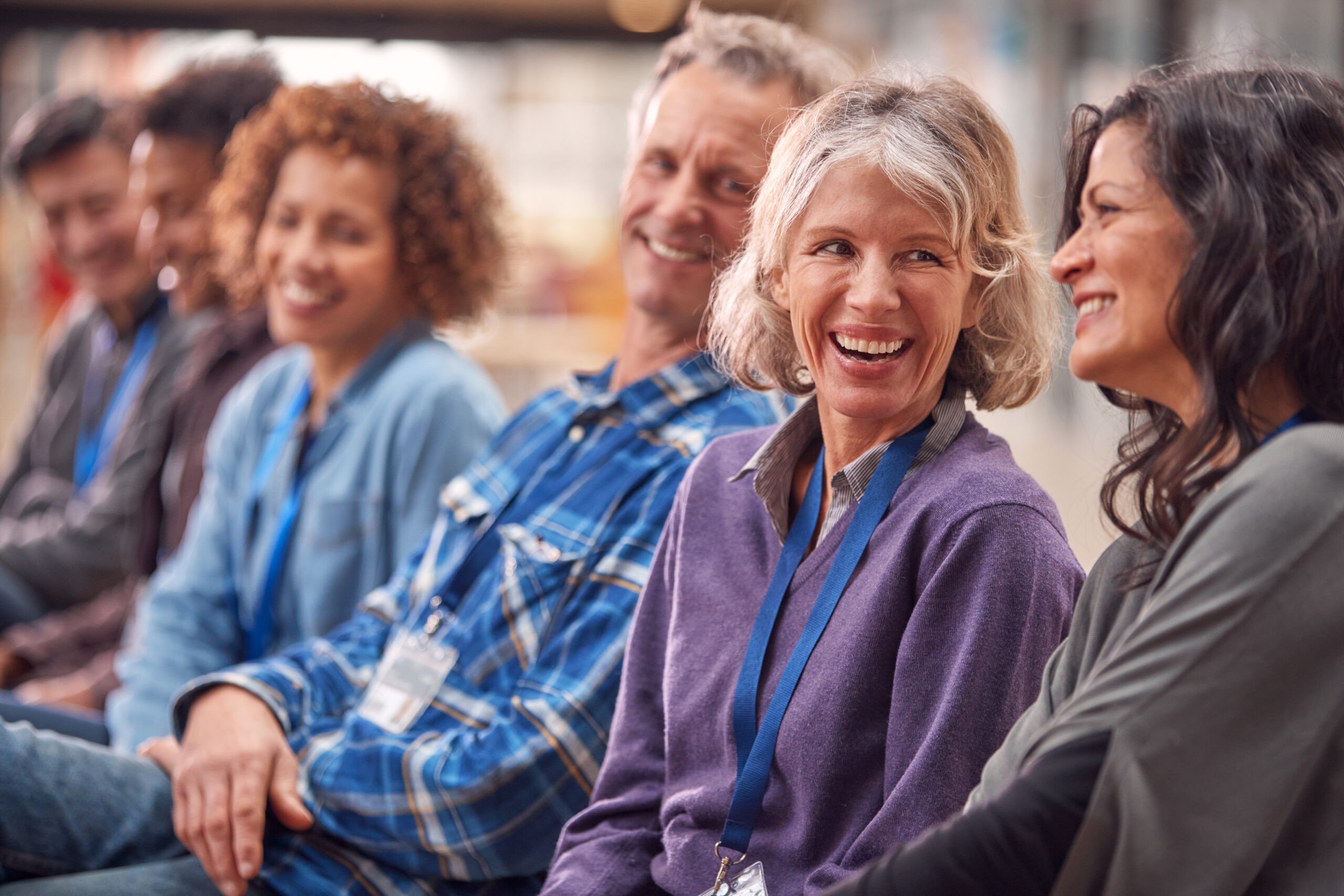 Group Of Casually Dressed individuals smiling and warmly looking at each other